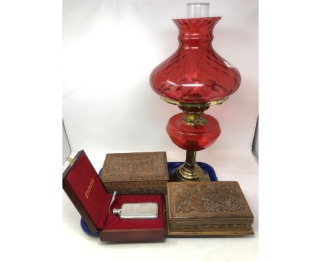 A tray of brass oil lamp with cranberry glass shade, cased Selangor pewter hip flask, two eastern carved trinket boxes. 