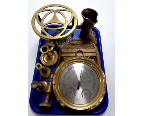 A tray containing assorted antique and later brass wares to include crumb scoop and shovel, trivet candlesticks together with