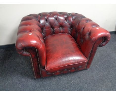 A red button leather Chesterfield club armchair  