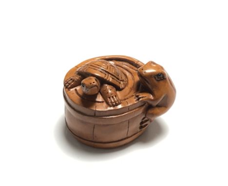 A carved Chinese hardwood netsuke - Turtle and frog by a barrel