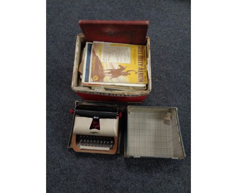 A vintage Lilliput typewriter together with a box containing a large quantity of sheet music 