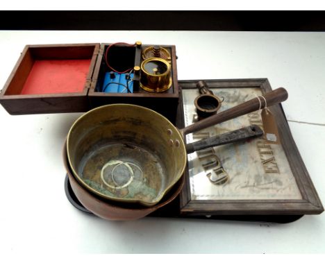 A tray containing two antique copper and brass pans, Guinness advertising mirror, miniature brass miner's lamp, cased instrum