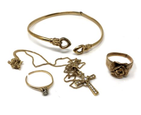 A 9ct gold bangle and two yellow metal rings (3 - a/f), together with a 9ct gold crucifix pendant on chain. (4) CONDITION REP