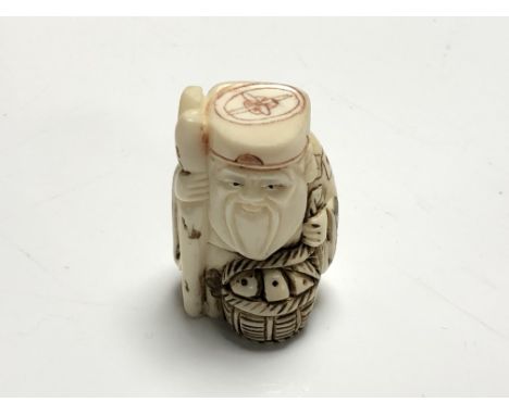 A carved Chinese bone netsuke - Gentleman holding a basket 