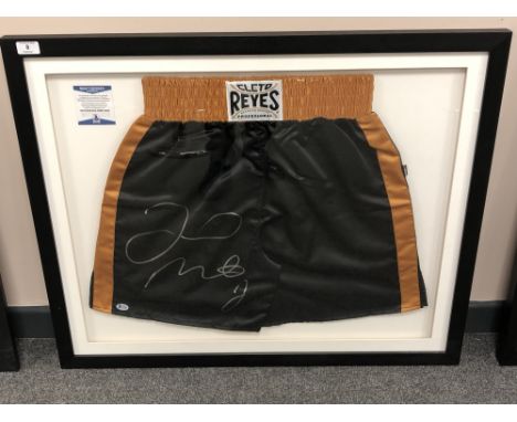 A sporting memorabilia montage : A signed pair of boxing shorts, Floyd Mayweather Jr., with Beckett certificate of authentici