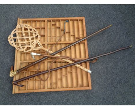 A printer's type tray together with two walking sticks, a riding crop and a carpet beater   