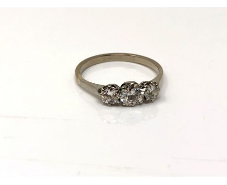 A good antique platinum three stone diamond ring, the central stone approximately 0.5ct. Size M. CONDITION REPORT: 12.46 mm t