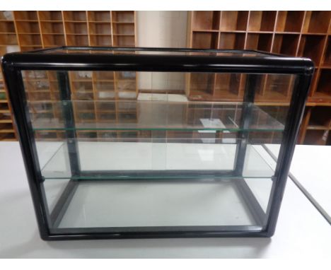 A counter top display cabinet with sliding glass doors