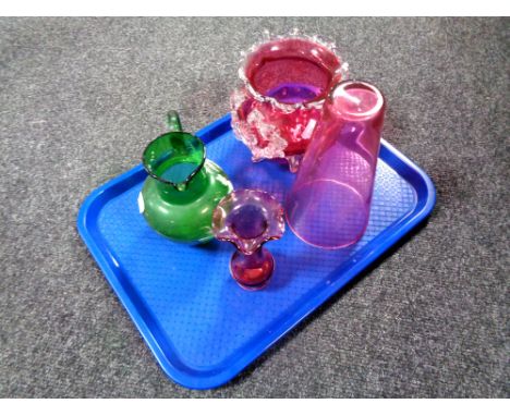 A tray containing four pieces of antique glassware to include a hand painted green glass jug, a cranberry glass bowl on raise