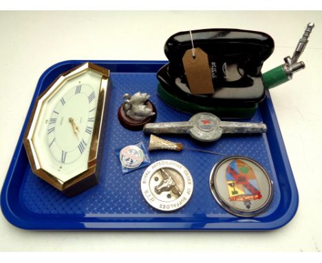 A tray containing a vintage Rhythm gas iron, car badges, Italian pin badge, hat pin etc 