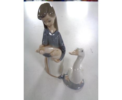 A Lladro figure, girl with pig, together with a further Lladro figure of a duck 