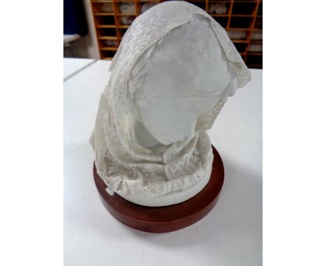 A Lladro bust, The Madonna, with sugar spun headdress (as found) on wooden base