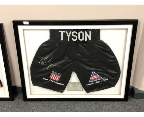 A sporting memorabilia montage : A signed pair of boxing shorts, Mike Tyson 'Kid Dynamite', with certificate of authenticity 