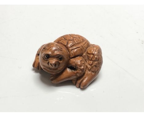 A carved Chinese hardwood netsuke - Mythical turtle creature 