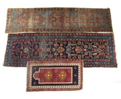 Collection of floor coverings Late 19th/early 20th Century, to include a runner, Persian, navy ground and decorated with vari