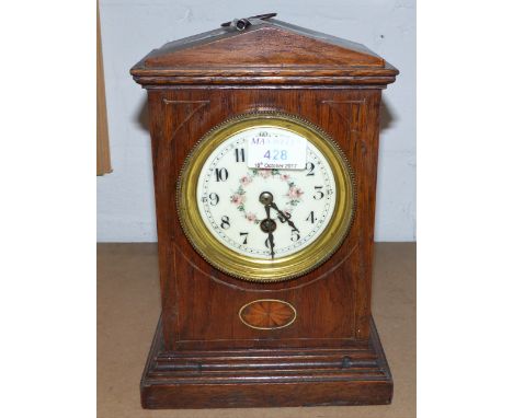 An inlaid oak mantel clock with floral dial and timepiece movement