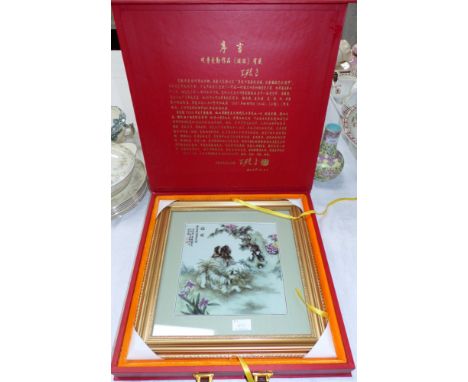 A Chinese painted ceramic tile picture depicting dogs, in display case