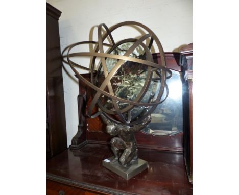 A modern solar lantern with multifaceted lens in armillary surround, having a figural support, 29½"