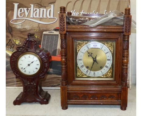 An Edwardian oak architectural mantel clock with brass dial and ting tang movement