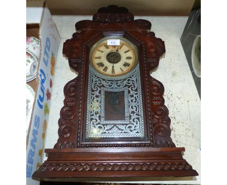 A 19th century American striking mantel clock; a tile teapot stand; an oak biscuit barrel