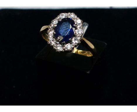 A dress ring set sapphire and diamonds, the yellow metal shank stamped '18CT'