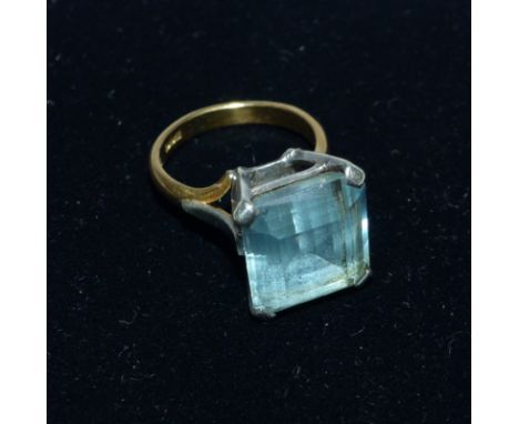 A dress ring set with aquamarine coloured stone, the shank hallmarked '22CT'