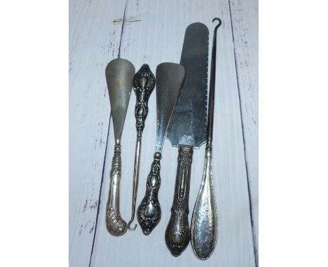 A silver handle pie slice; 2 silver handled button hooks; 2 shoe horns