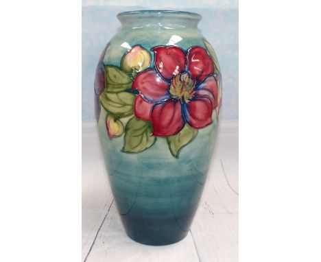 A Moorcroft large baluster vase decorated with clematis against a light blue ground, impressed, signed and bearing original  