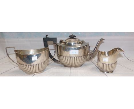 A late Georgian style silver 3 piece tea service of boat form with gadrooned decoration, the teapot with ebony mounts, 31 oz,