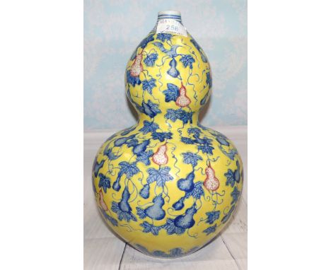 A Chinese porcelain double gourd shaped vase with underglaze blue decoration on raised yellow enamel ground, 12"