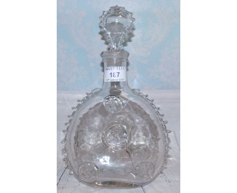 A pilgrim flask decanter with fleur-de-lys prints, 11"; a Clarice Cliff Bizarre Secrets pattern dish; another in the Ravel pa