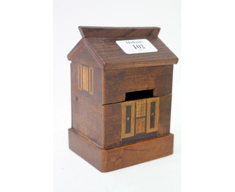 A 19TH CENTURY FOLK ART NOVELTY MONEY BOX in the form of a house with parquetry decoration, 13cm