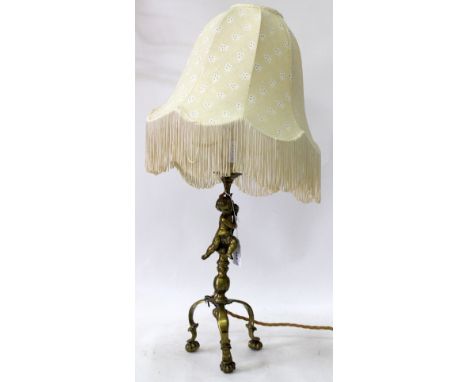 A 19TH CENTURY BRASS LAMP of cherub form, 34cm in height
