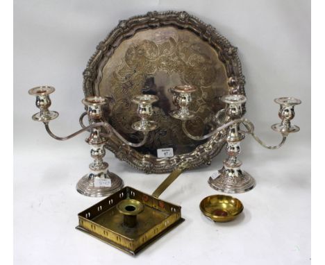 A GARRARD & CO SILVER PLATED SALVER standing on pad feet with a gadrooned serpentine edge, two silver plated candelabra and a