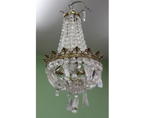 A HANGING CUT GLASS LIGHT FITTING  with brass frame, 40cm high overall
