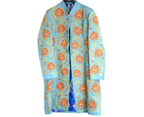 A turquoise silk weave long jacket, profusely embroidered with stylised Ottoman carnations and saz leaves with silk ikat lini