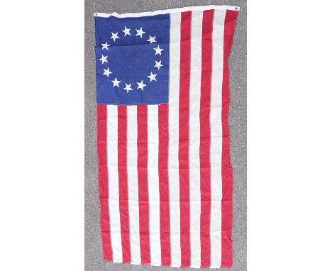 Vintage Betsey Ross style (early American) flag composed of machine stitched fabric panels for stripes and blue panel with pr