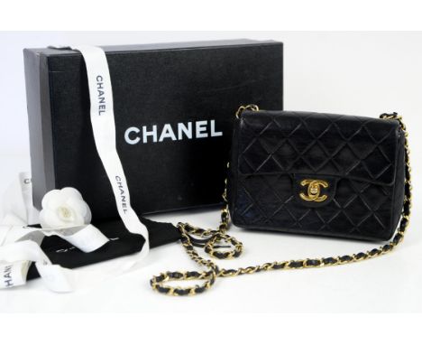 Vintage Chanel classic mini flap bag in black quilted lamb skin, red leather lining and gold hardware, with box, dustbag, rib