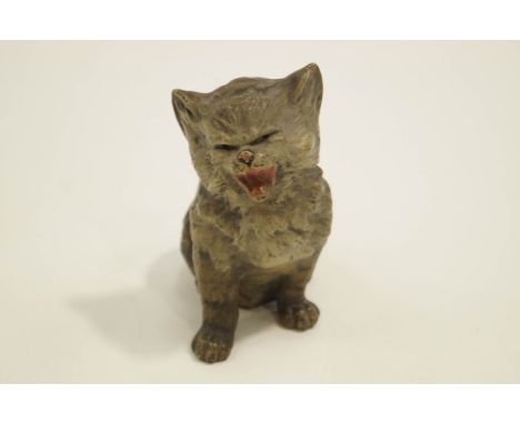 A ceramic model of a seated cat, in the style of  'Louis Wain' , suffragette interest, 15cm high 
