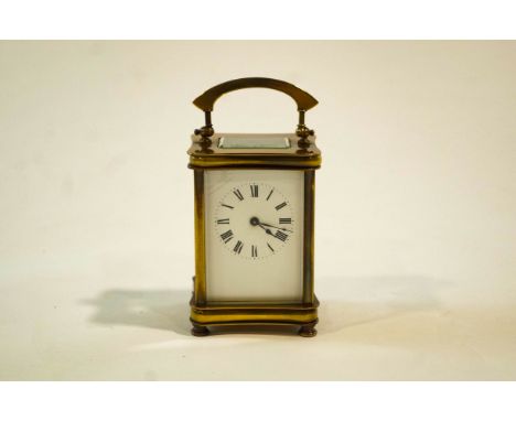 A 20th Century French brass carriage clock, enamelled with Roman numerals,12cm high
