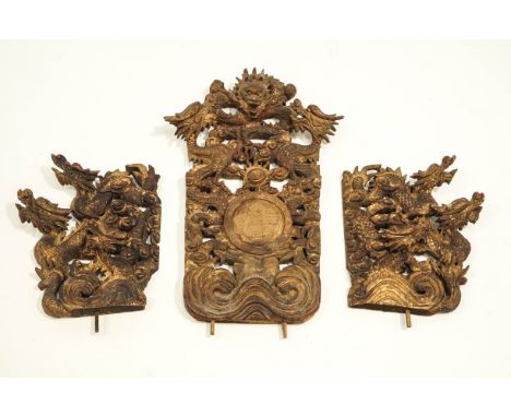 Three gilt wood Chinese mounts, all similarly carved with dragons and scroll work