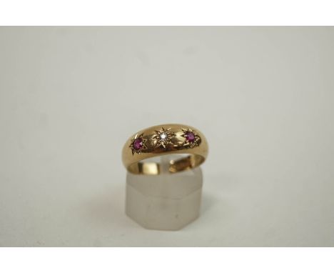 An early 20th century 18 carat gold, ruby and diamond three stone gypsy ring, hallmarked Chester 1916 by W&H Ltd, 3.8 grams g