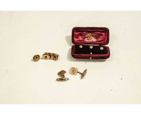 A pair of 9 carat gold cufflinks, the cushion shaped monogrammed panel chain linked to a torpedo shaped back; with two 9 cara