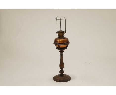 An early 20th Century brass lamp on a turned wooden pedestal base, 75cm high.