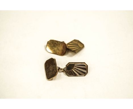 A pair of 9 carat gold cufflinks, by Freddie Manshaw, London 1965, the oval panel engraved with a sun burst, the back panel p
