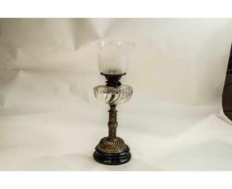 A VIctorian Oil lamp, with a spiral brass column and base, supporting a spiral glass reservoir and frosted glass shade, etche