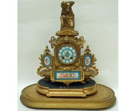 A 19th century French mantel clock with gilt metal case inset with Sèvres style plaques painted with flowers and putti on a b