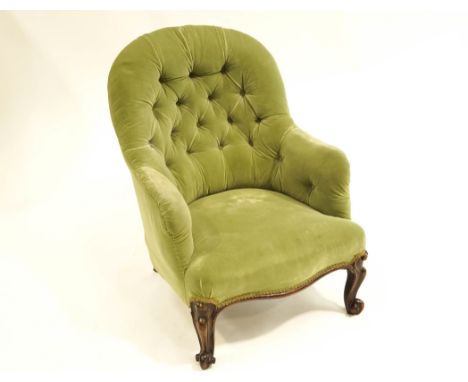 An early 20th Century button back chair with carved cabriole legs and shaped front, upholstered in green velvet