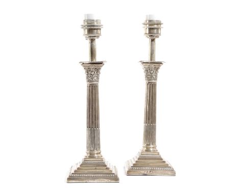 A PAIR OF EDWARDIAN SILVER CORINTHIAN COLUMN CANDLESTICK TABLE LAMPSEARLY 20TH CENTURYeach with a stop fluted stem on a stepp