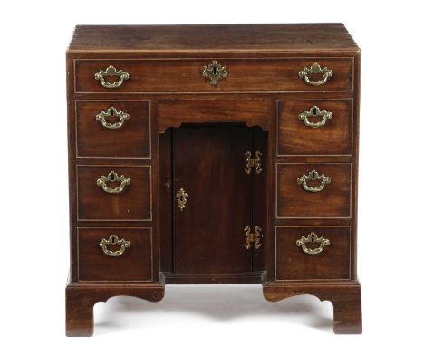 AN EARLY GEORGE III MAHOGANY KNEEHOLE DESK C.1760with a caddy moulded top above an arrangement of eight drawers around a cent